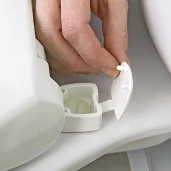 remove bolt caps to replace toilet seat