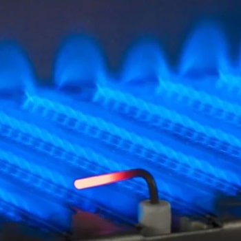 blue flames heating up water in an oil-fired boiler