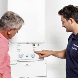 pro and homeowner discussing boiler installation costs