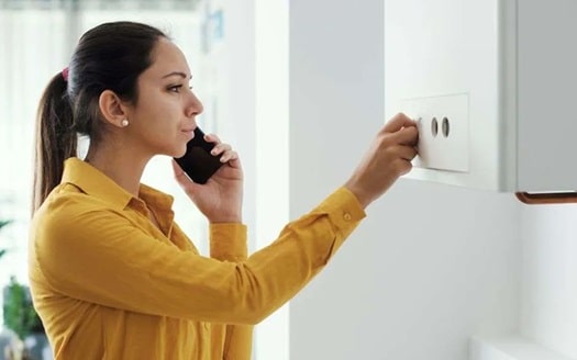 homeowner interacting with an electric boiler installation